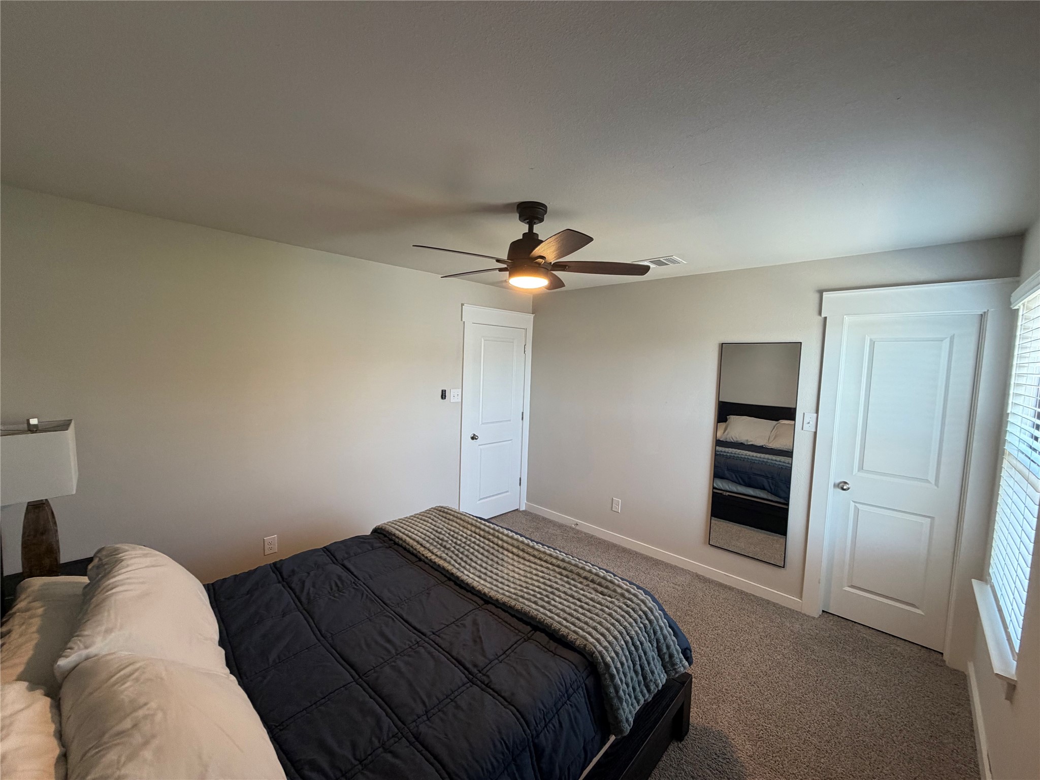 125 Threshing Road, Unit A Buda, TX 78610 - Photo 12 of 23 Carpeted bedroom featuring baseboards and a ceiling fan