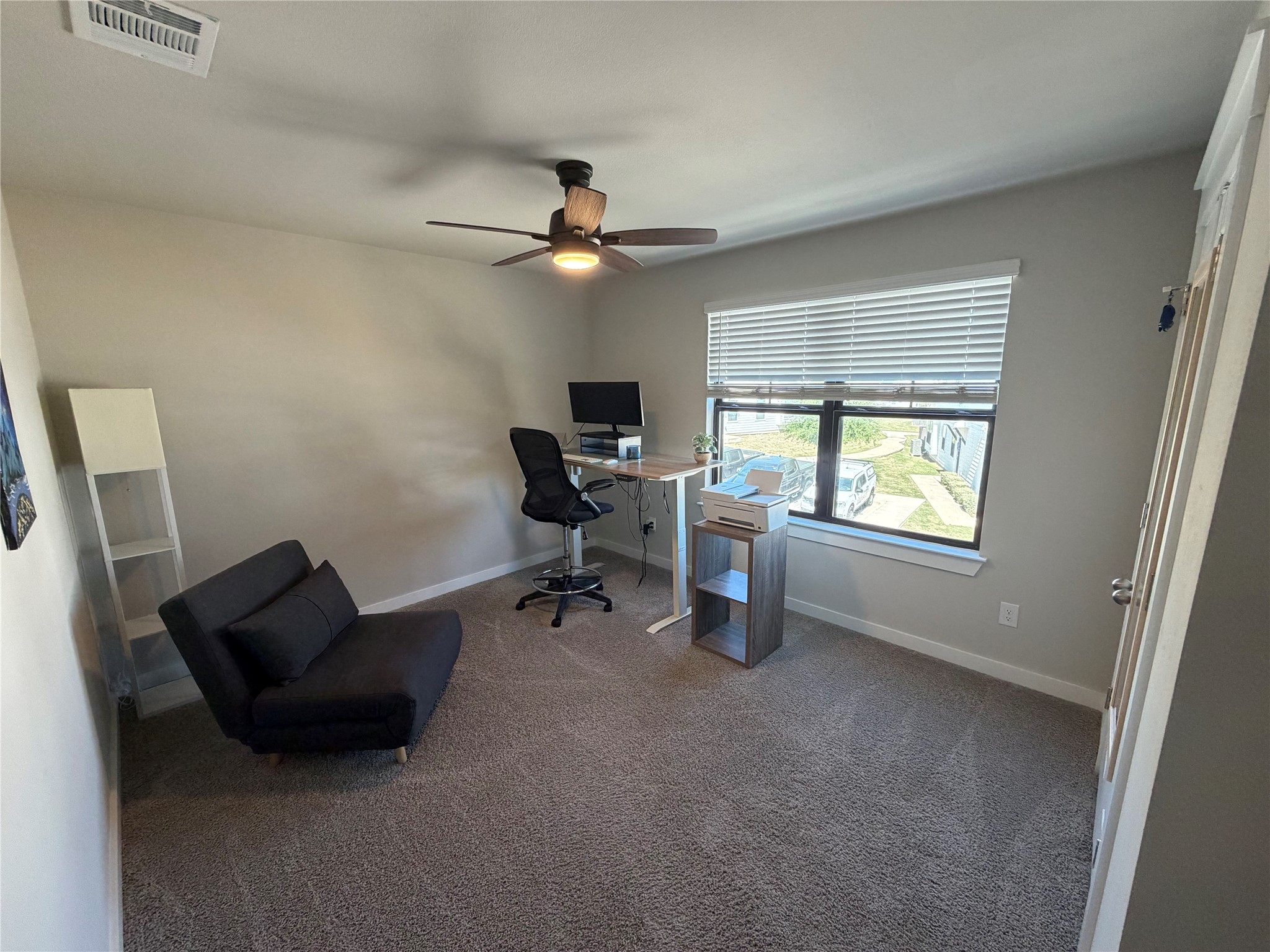 125 Threshing Road, Unit A Buda, TX 78610 - Photo 13 of 23 Home office featuring dark colored carpet and ceiling fan