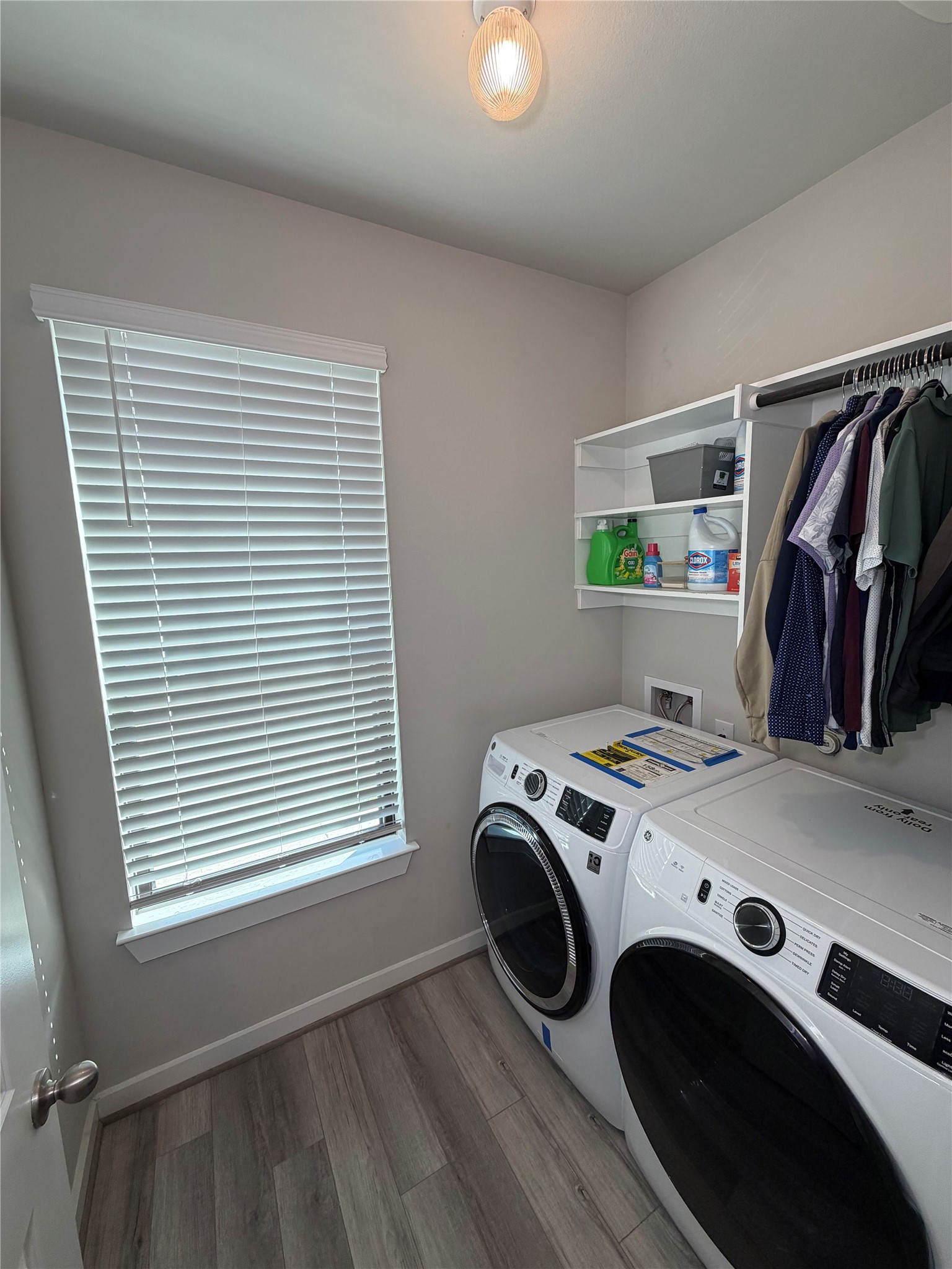 125 Threshing Road, Unit A Buda, TX 78610 - Photo 17 of 23 Laundry room with light wood-type flooring and washer and dryer