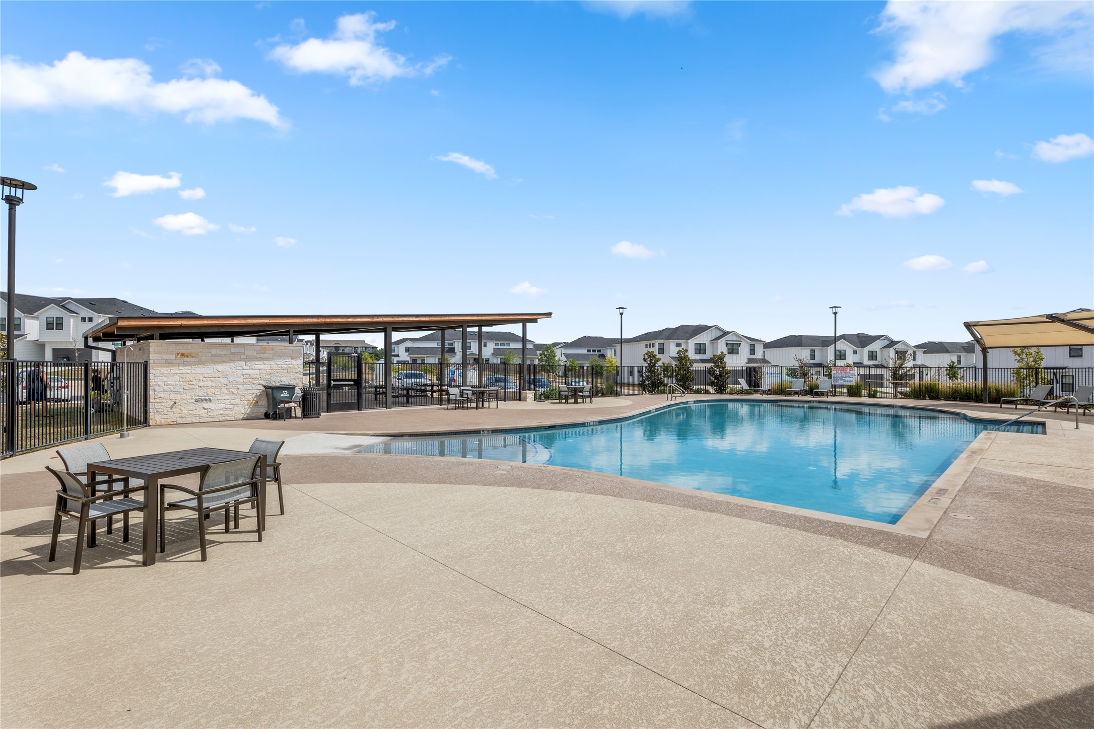 125 Threshing Road, Unit A Buda, TX 78610 - Photo 22 of 23 Community pool featuring a patio area and a residential view