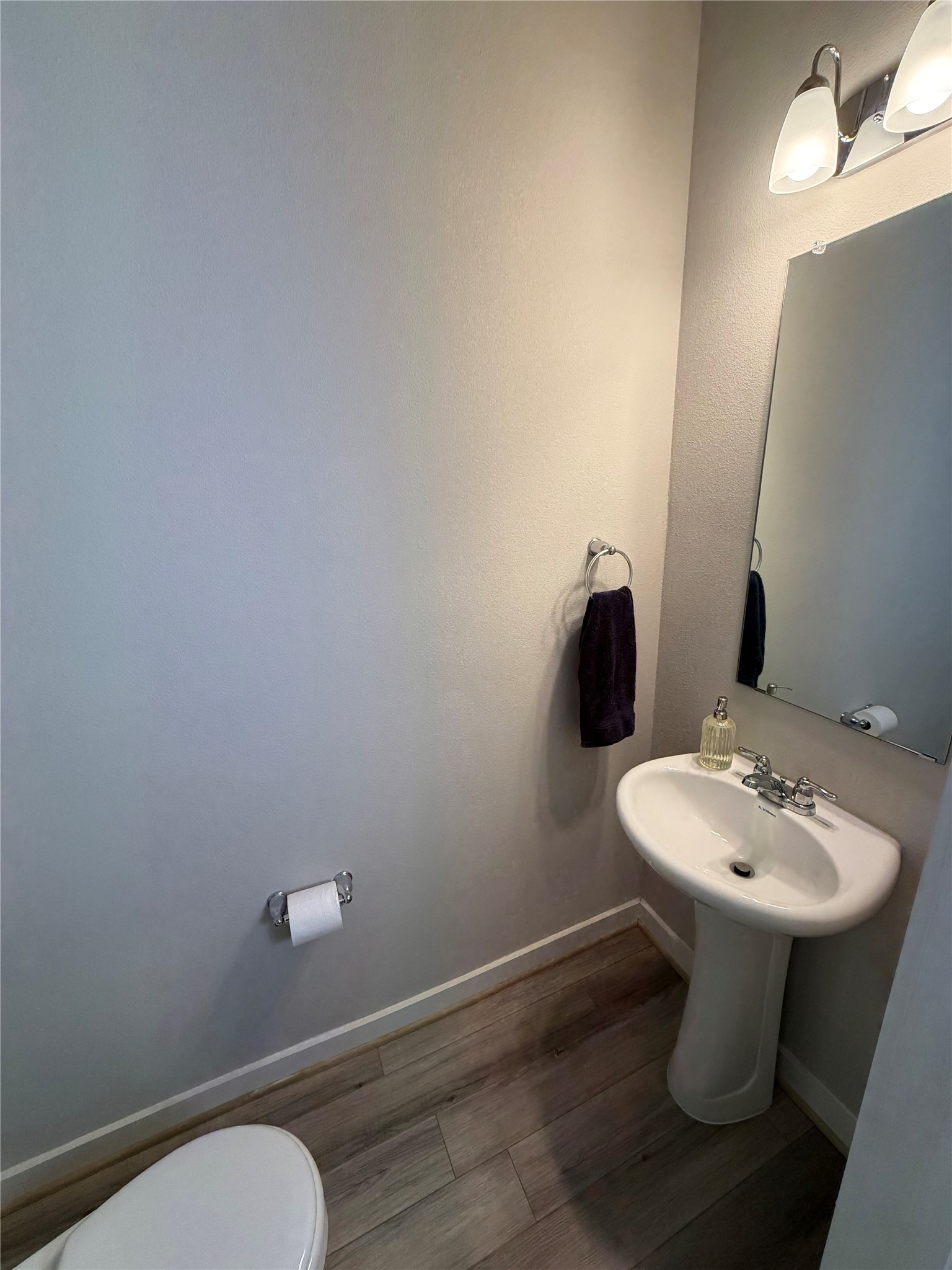 125 Threshing Road, Unit A Buda, TX 78610 - Photo 5 of 23 Bathroom with wood finished floors and toilet