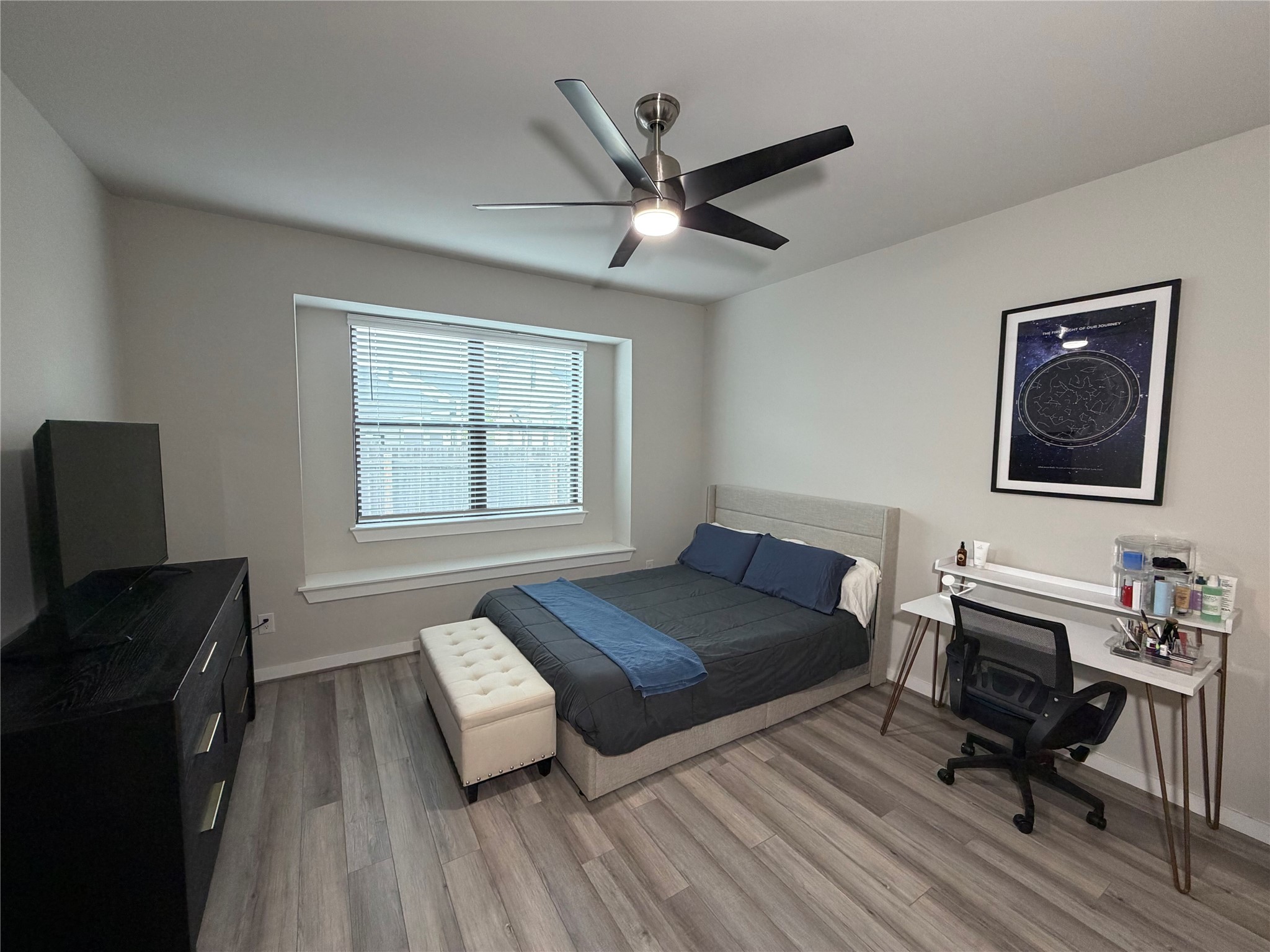 125 Threshing Road, Unit A Buda, TX 78610 - Photo 6 of 23 Bedroom featuring light wood-style flooring, a ceiling fan, and a desk