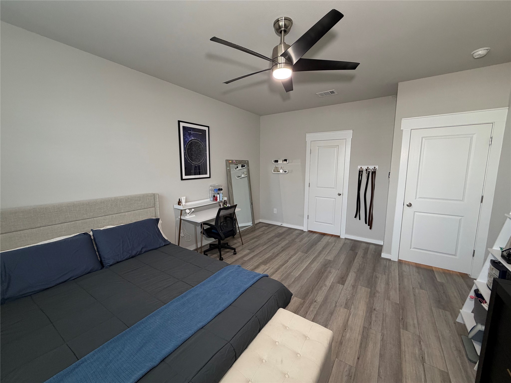 125 Threshing Road, Unit A Buda, TX 78610 - Photo 7 of 23 Bedroom with dark wood-style flooring, a desk, and a ceiling fan