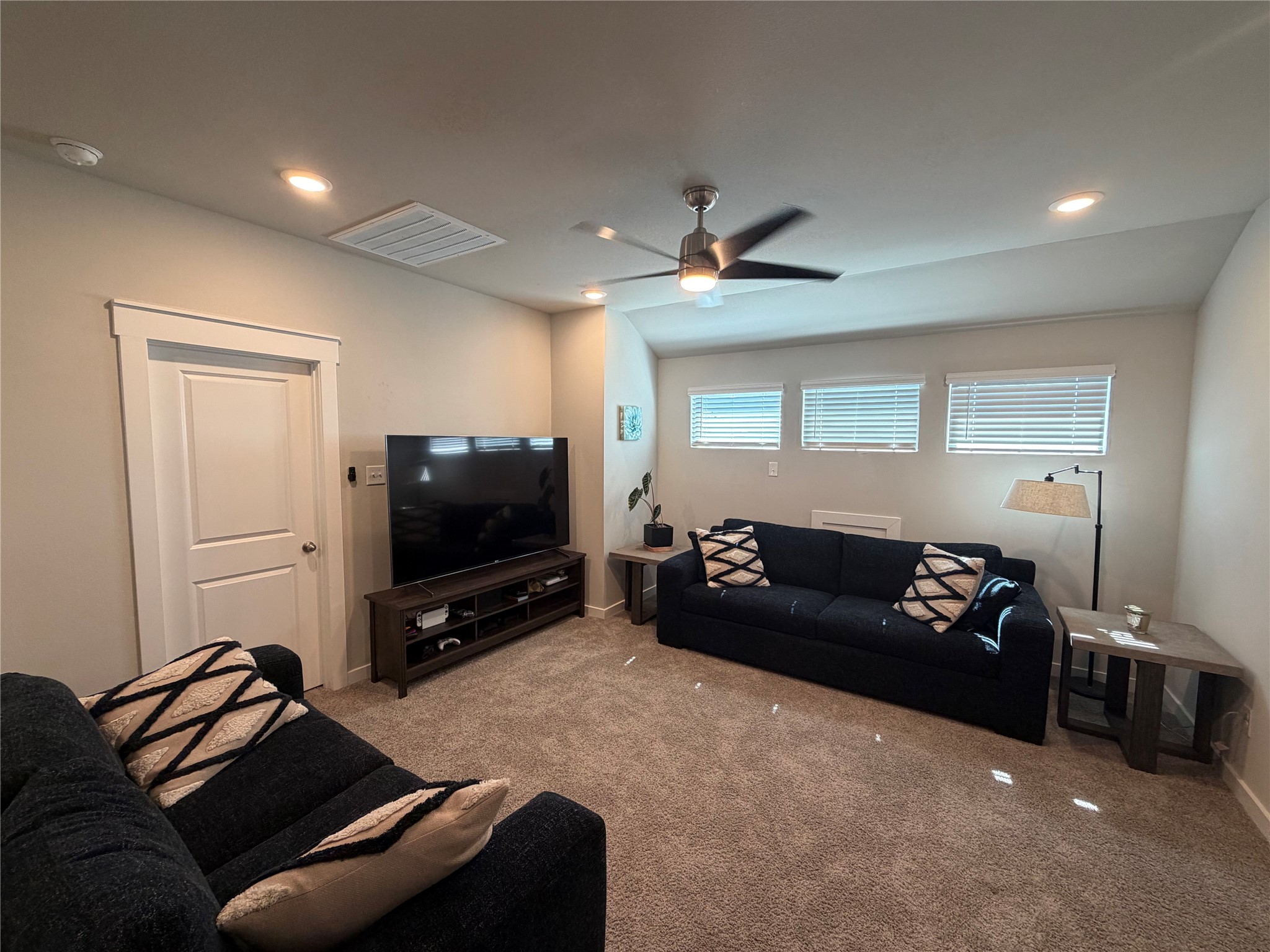 125 Threshing Road, Unit A Buda, TX 78610 - Photo 10 of 23 Carpeted living room featuring recessed lighting and a ceiling fan