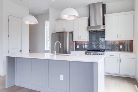 a kitchen with cabinets and window