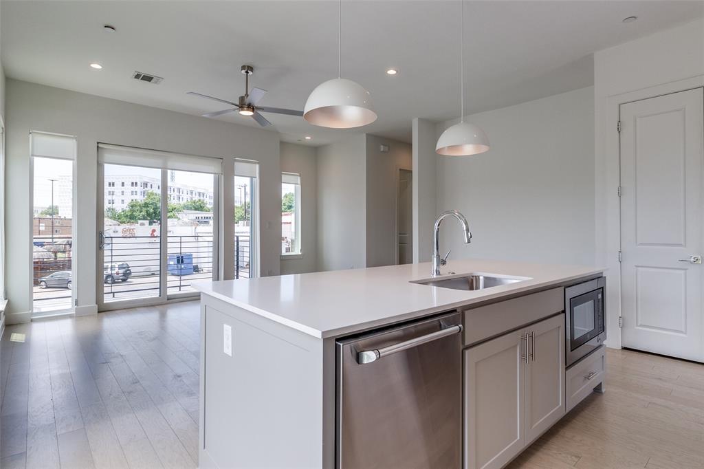 5515 Bryan Parkway, Unit 101 Dallas, TX 75206 - Photo 12 of 19 a kitchen with a sink chandelier and wooden floor