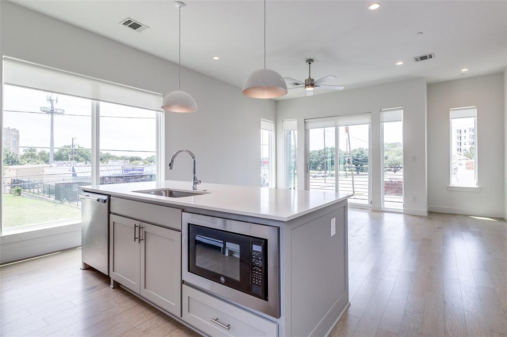 5515 Bryan Parkway, Unit 101 Dallas, TX 75206 - Photo 14 of 19 a kitchen with a stove and a large window