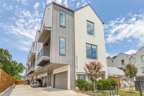 a front view of a house with a tree
