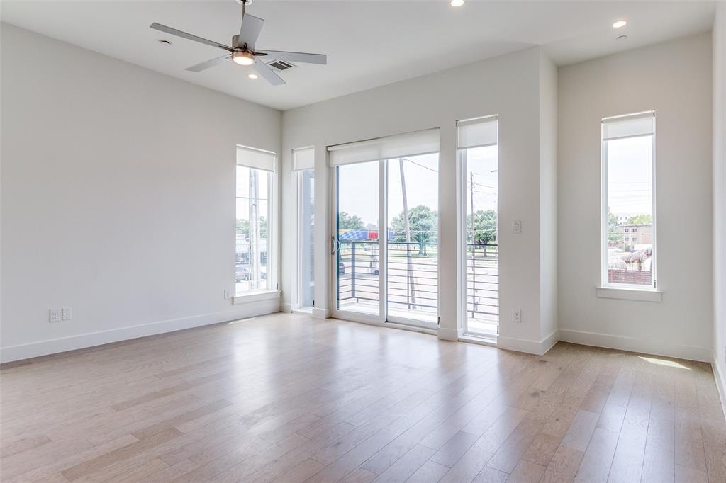 5515 Bryan Parkway, Unit 101 Dallas, TX 75206 - Photo 3 of 19 a view of an empty room with wooden floor and a window
