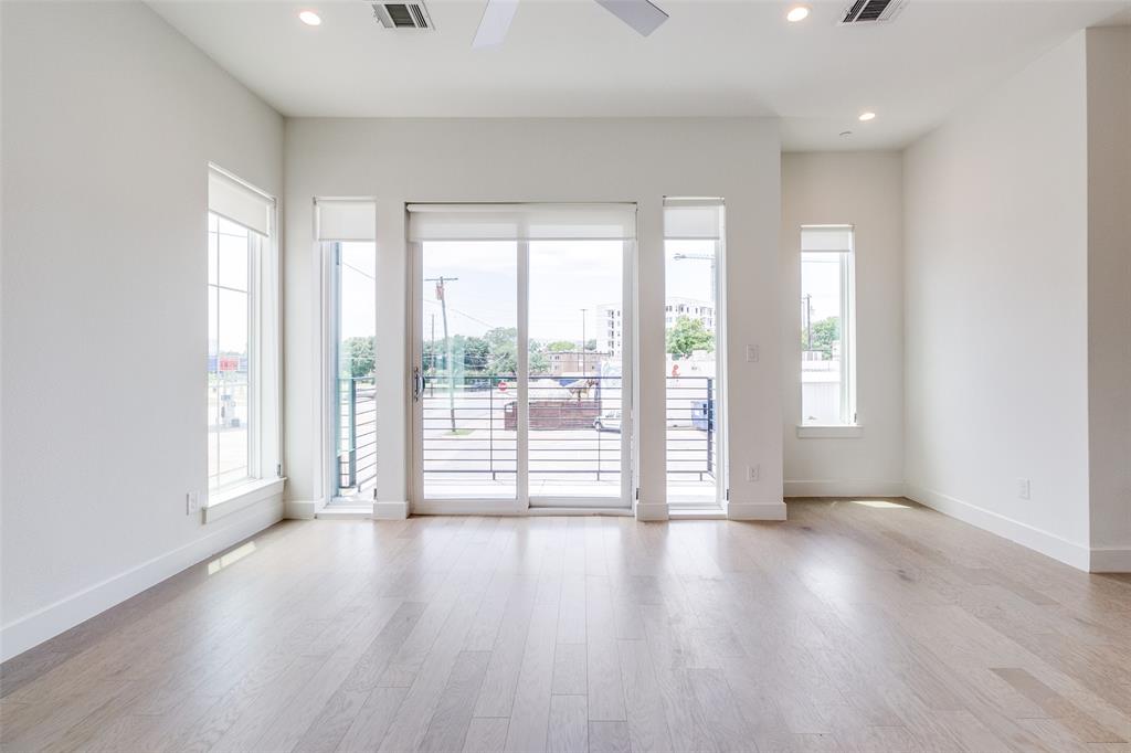5515 Bryan Parkway, Unit 101 Dallas, TX 75206 - Photo 4 of 19 a view of an empty room with wooden floor and a window