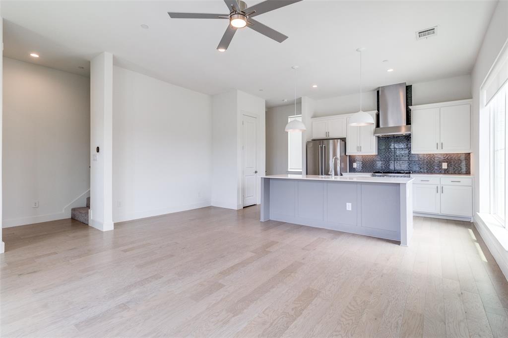 5515 Bryan Parkway, Unit 101 Dallas, TX 75206 - Photo 6 of 19 a large kitchen with cabinets and wooden floor