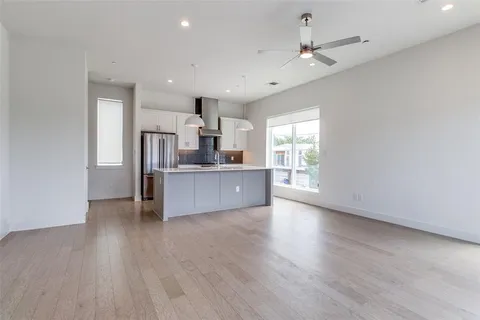 a view of a kitchen with a sink cabinets and wooden floor