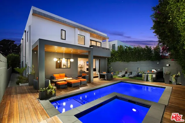 a room with pool table and chairs in patio