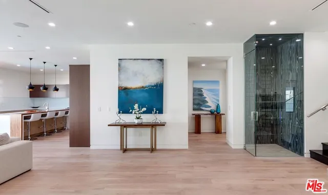 a view of kitchen with kitchen island wooden cabinets and refrigerator