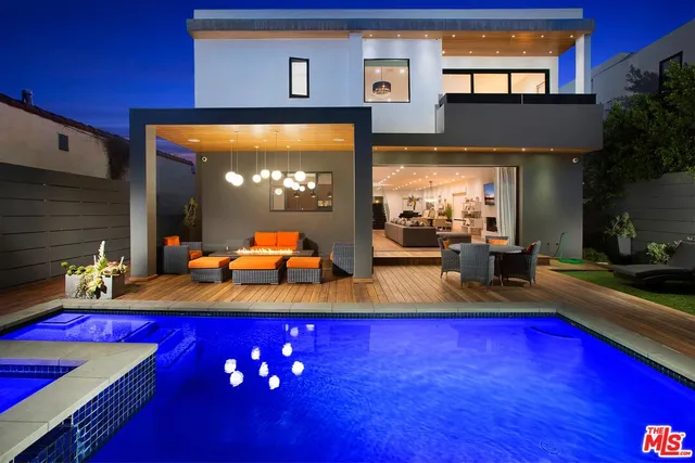 a living room with table chairs and a large window