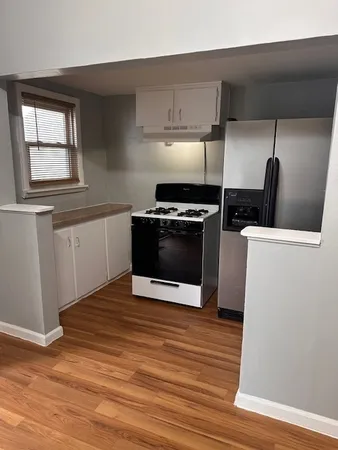 a kitchen with granite countertop a stove and a microwave