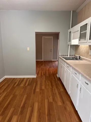 a view of kitchen with sink and wooden floor