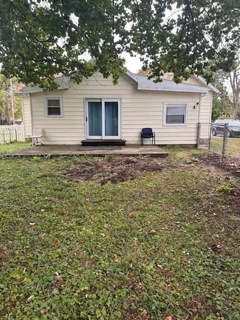 a view of a house with a backyard
