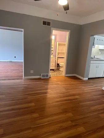 a view of room with window and wooden floor