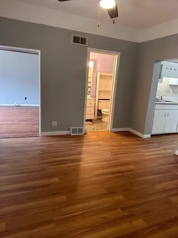 a view of room with window and wooden floor