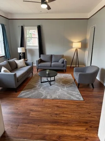 a living room with furniture and a lamp