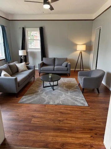 a living room with furniture and a lamp
