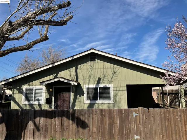 a view of a house with wooden fence