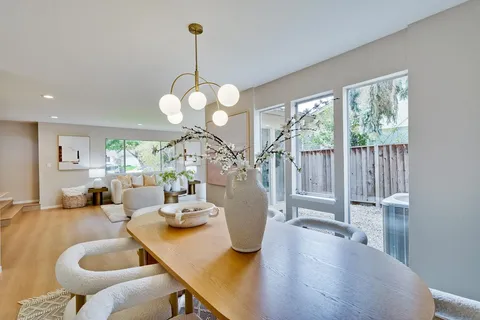a view of a dining room with furniture wooden floor and chandelier