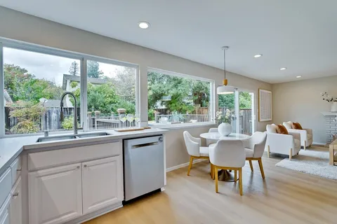 a living room with furniture and kitchen view