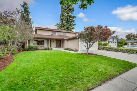 a view of house with yard and entertaining space