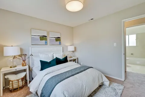 a workspace room with furniture and a potted plant