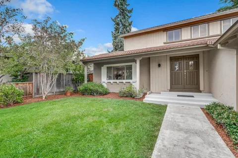 a front view of a house with garden