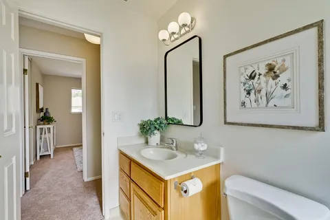 a bedroom with a bed and a potted plant