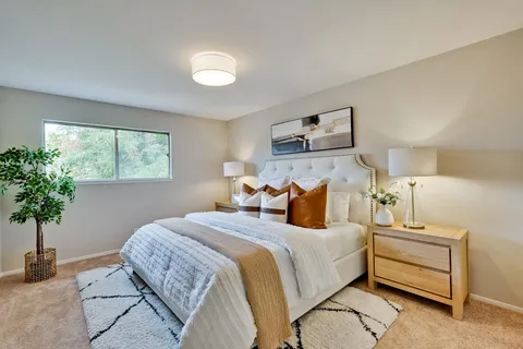 a bedroom with bed and a view of bedroom