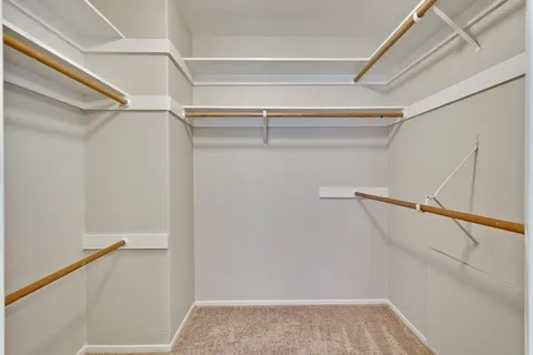 a view of a kitchen cabinets and a refrigerator