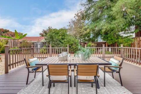 a view of a backyard with sitting area