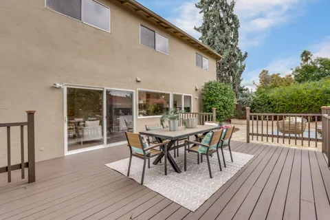 a view of a house with backyard and deck
