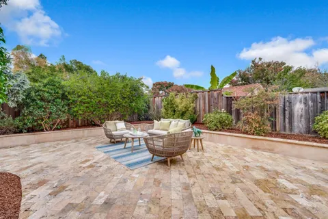 a view of a patio with couches and a potted plant