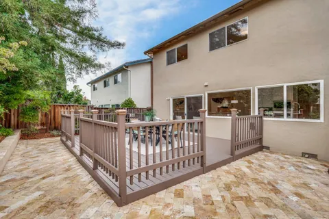 a view of a balcony and yard