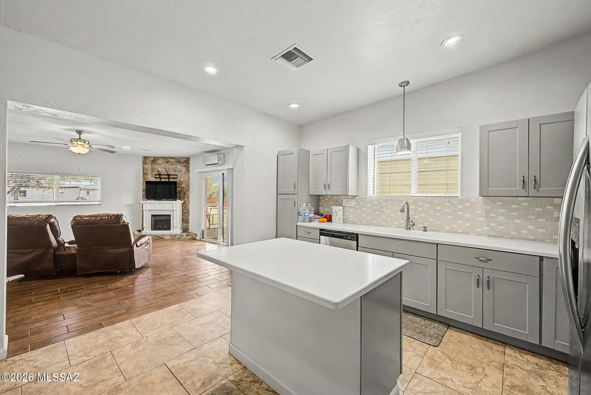 4231 East Pinal Street Tucson, AZ 85739 - Photo 30 of 36 a large kitchen with stainless steel appliances a stove a sink a oven a dining table and chairs