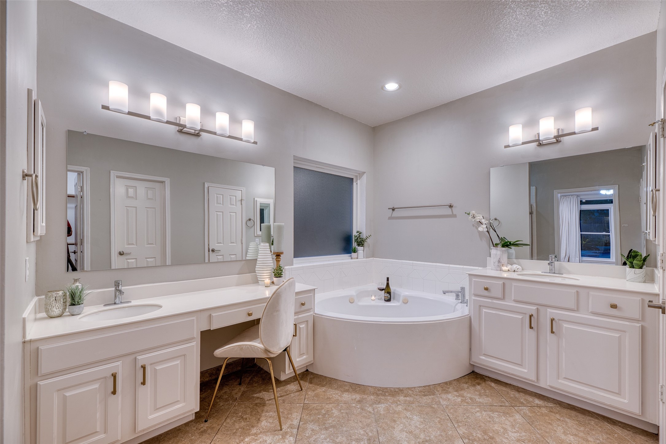 19303 Allview Lane Houston, TX 77094 - Photo 26 of 50 Primary bathroom featuring dual vanities, soaking tub, and elegant lighting.