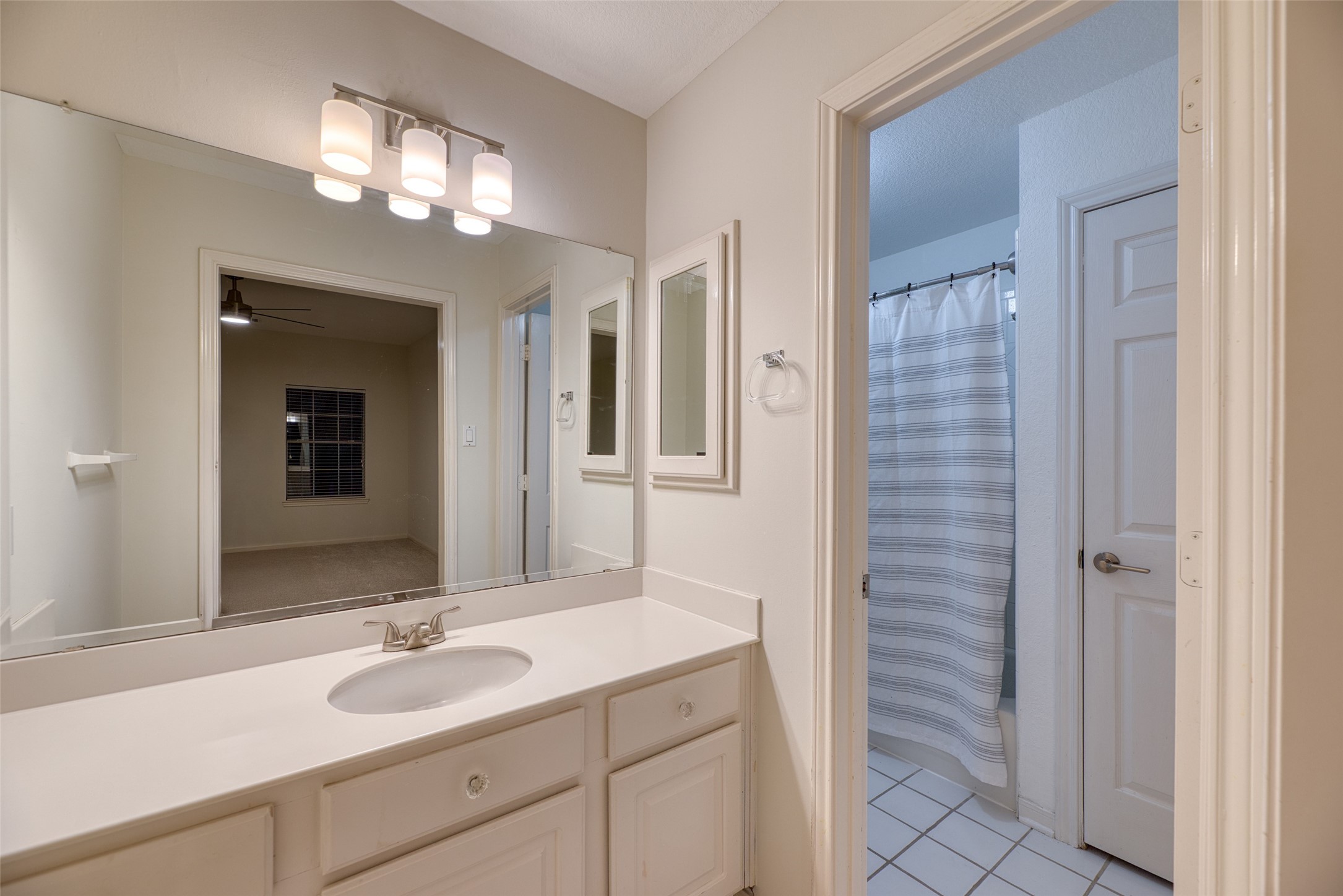 19303 Allview Lane Houston, TX 77094 - Photo 34 of 50 Secondary bathroom with extended vanity and modern lighting.