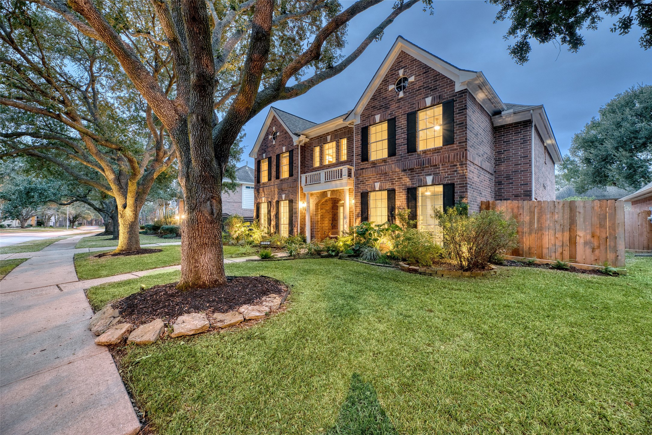19303 Allview Lane Houston, TX 77094 - Photo 44 of 50 Front yard and side elevation with mature landscaping and lighting.