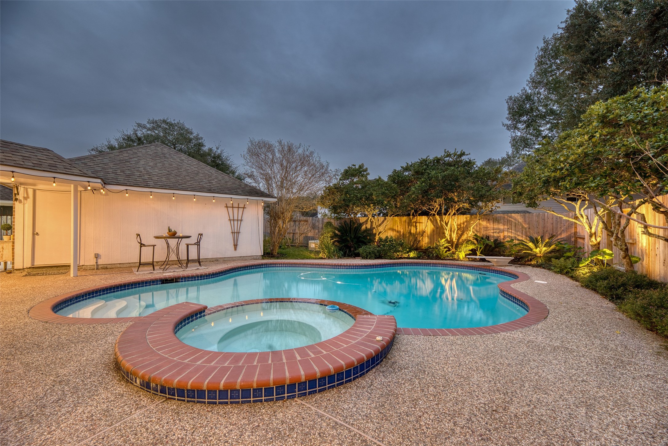19303 Allview Lane Houston, TX 77094 - Photo 46 of 50 Resort-style backyard featuring a sparkling pool and raised spa, perfect for outdoor entertaining.