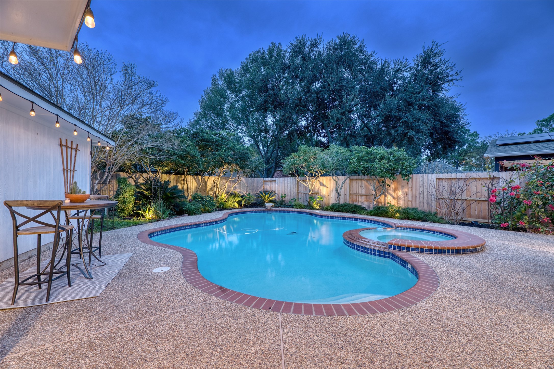 19303 Allview Lane Houston, TX 77094 - Photo 48 of 50 Evening pool view showcasing expansive patio and tranquil backyard setting.