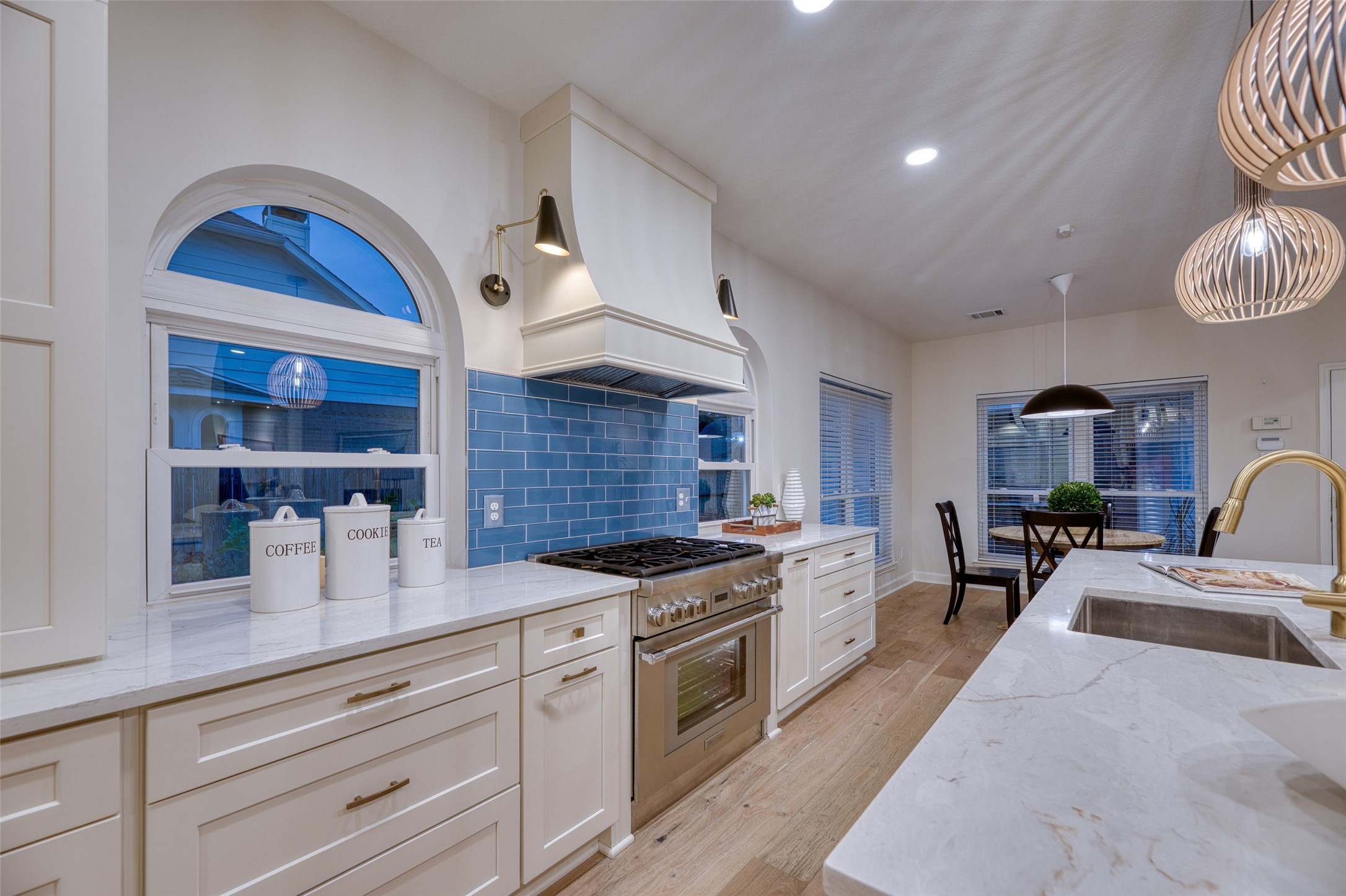 19303 Allview Lane Houston, TX 77094 - Photo 10 of 50 Statement Thermador gas range with custom vent hood and striking blue tile backsplash.