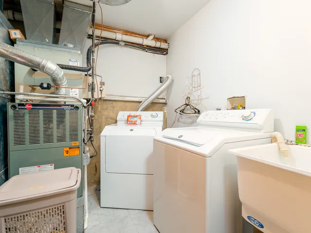 a view of a house with a yard and large tree