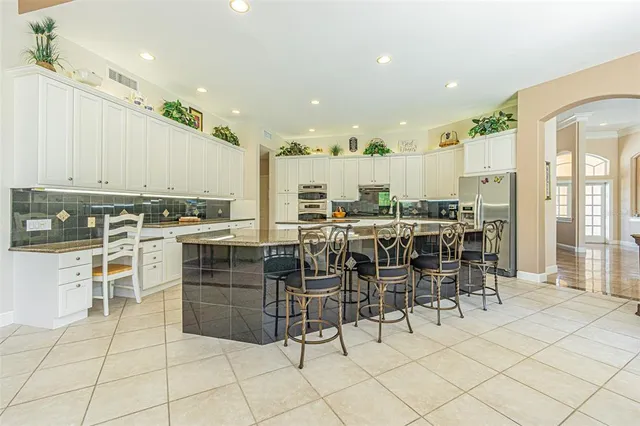 a kitchen with stainless steel appliances granite countertop a sink and cabinets