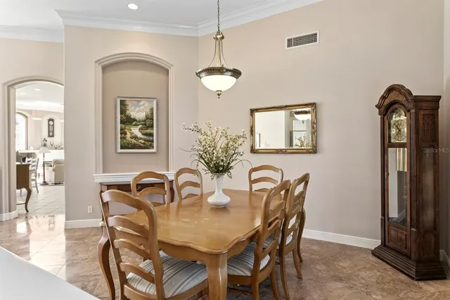 a kitchen with stainless steel appliances kitchen island granite countertop a table and chairs in it