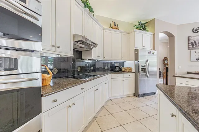 a dining room with furniture a fireplace and large windows